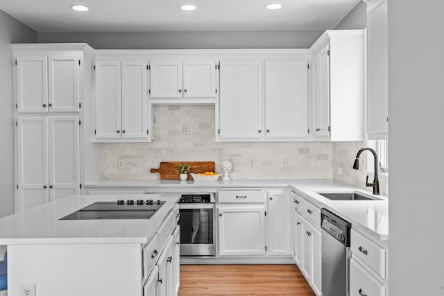 3868 Green Heights Trl SW, Prior Lake, MN 55372 - kitchen with stainless steel appliances, light countertops, white cabinets, and recessed lighting