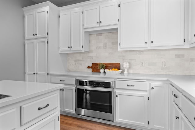 3868 Green Heights Trl SW, Prior Lake, MN 55372 - kitchen with oven, light countertops, white cabinets, backsplash, and light wood-type flooring