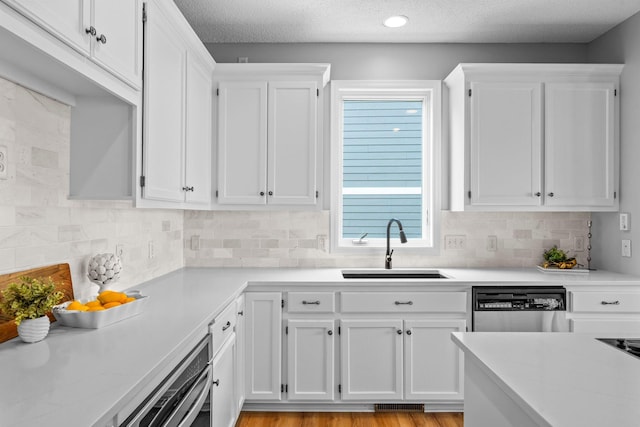 3868 Green Heights Trl SW, Prior Lake, MN 55372 - kitchen featuring stainless steel dishwasher, white cabinets, light countertops, and a textured ceiling