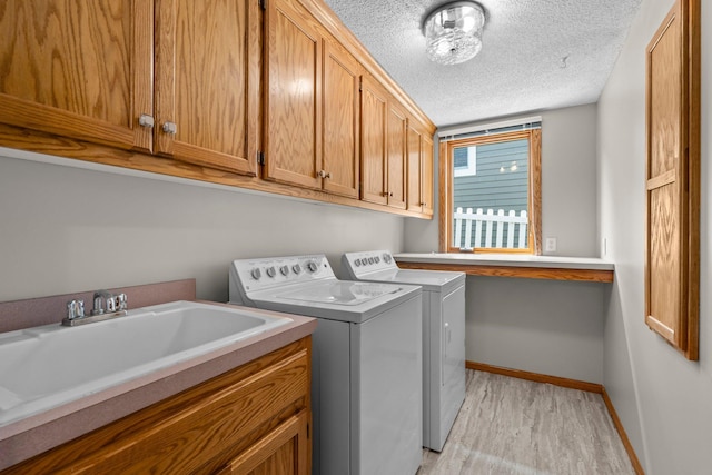 3868 Green Heights Trl SW, Prior Lake, MN 55372 - washroom with separate washer and dryer, a textured ceiling, cabinet space, and light wood-style floors