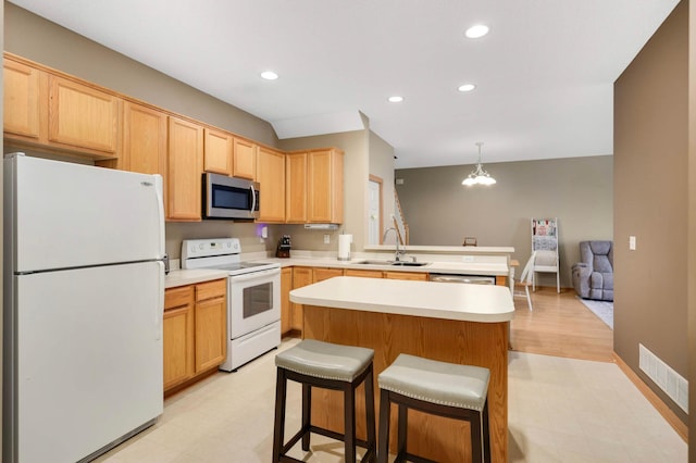 5220 Hummingbird Ln Unit 176, Farmington, MN 55024 - kitchen featuring white appliances, light brown cabinets, light floors, a peninsula, and light countertops