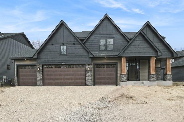 20141 63rd Ave, Corcoran, MN 55340 - craftsman house featuring a garage, stone siding, and gravel driveway