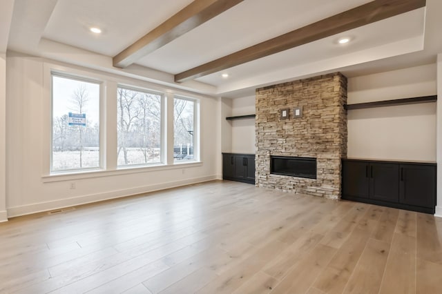 20141 63rd Ave, Corcoran, MN 55340 - unfurnished living room with a fireplace, beamed ceiling, light wood-style flooring, and baseboards