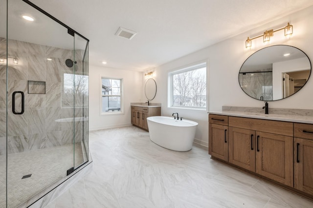 20141 63rd Ave, Corcoran, MN 55340 - full bathroom featuring vanity, a marble finish shower, a freestanding tub, baseboards, and recessed lighting