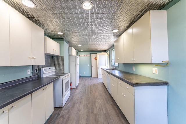 25 4th Ave, Soudan, MN 55782 - kitchen with white appliances, dark countertops, white cabinetry, dark wood finished floors, and recessed lighting