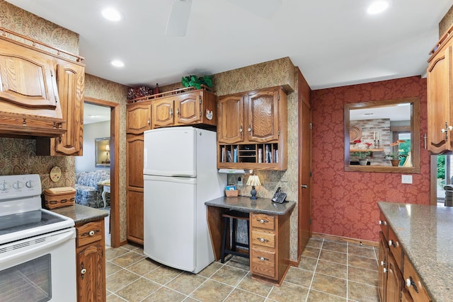 2657 Valley View Ln, New Brighton, MN 55112 - kitchen featuring white appliances, wallpapered walls, recessed lighting, dark countertops, and brown cabinetry