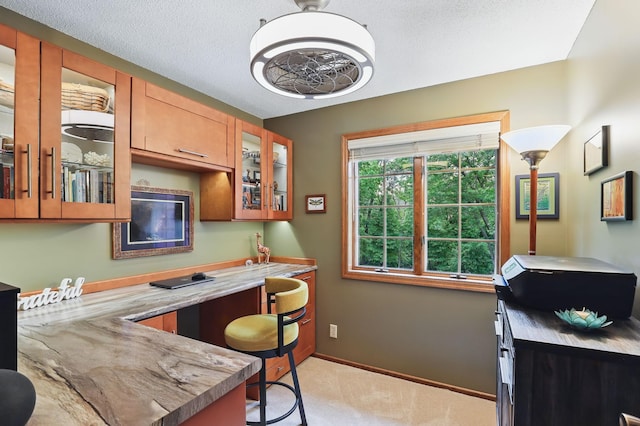 2657 Valley View Ln, New Brighton, MN 55112 - kitchen featuring light carpet, glass insert cabinets, and brown cabinetry