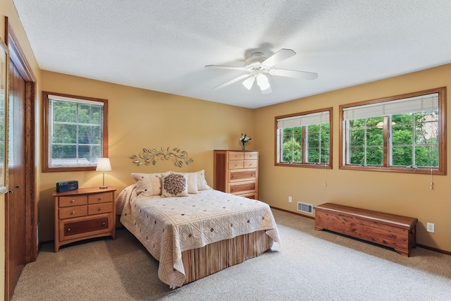 2657 Valley View Ln, New Brighton, MN 55112 - bedroom with light colored carpet, multiple windows, a textured ceiling, a closet, and ceiling fan