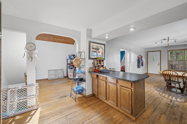 132 Middle School Dr, Saint Croix Falls, WI 54024 - kitchen with arched walkways, a peninsula, wood finished floors, dark countertops, and recessed lighting