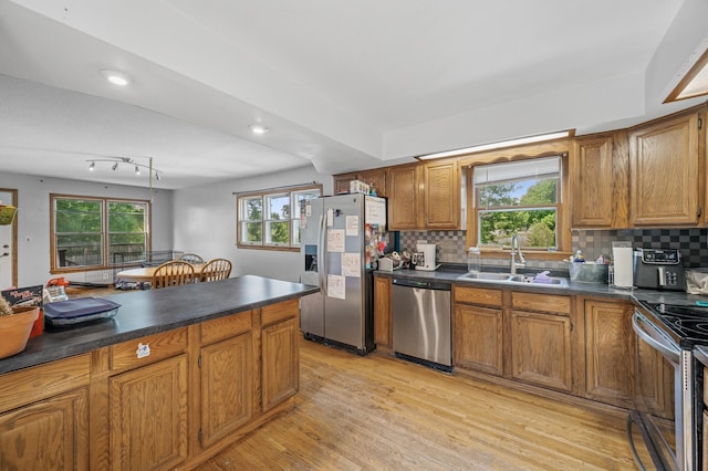 132 Middle School Dr, Saint Croix Falls, WI 54024 - kitchen with appliances with stainless steel finishes, a sink, dark countertops, brown cabinetry, and recessed lighting