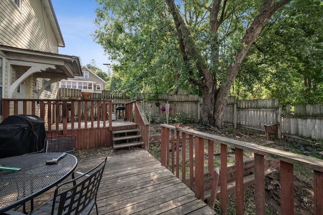 132 Middle School Dr, Saint Croix Falls, WI 54024 - wooden deck with a fenced backyard, outdoor dining space, and a grill