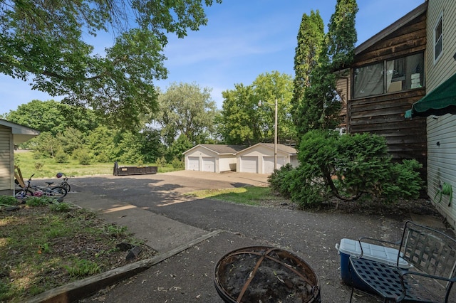 132 Middle School Dr, Saint Croix Falls, WI 54024 - view of yard with a detached garage, an outdoor structure, and view of scattered trees