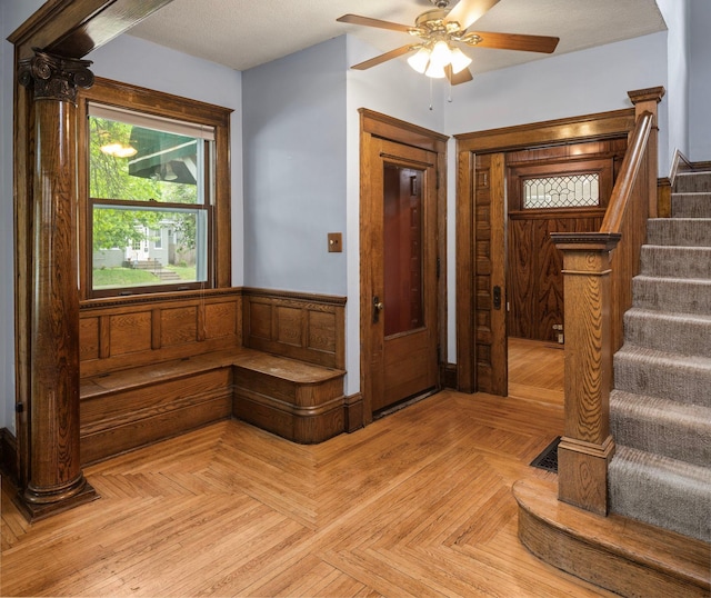 3225 Hennepin Ave, Minneapolis, MN 55408 - entryway featuring stairs, a wainscoted wall, and ceiling fan