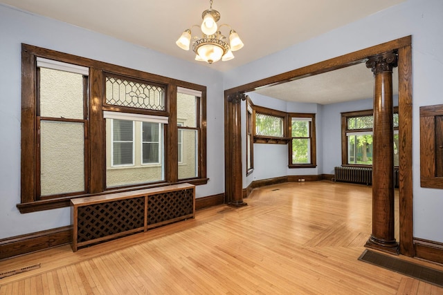 3225 Hennepin Ave, Minneapolis, MN 55408 - empty room featuring baseboards, a chandelier, radiator, and light wood-type flooring