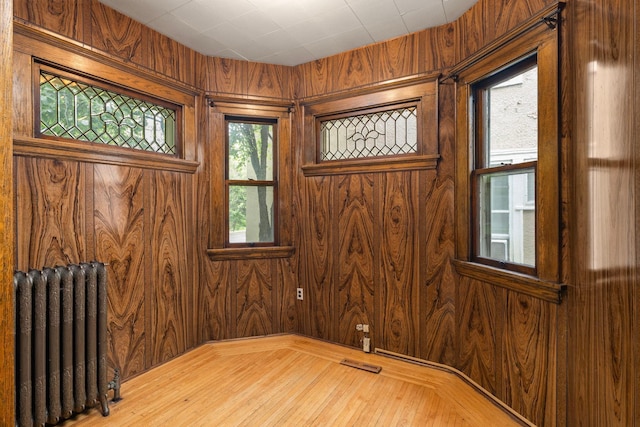3225 Hennepin Ave, Minneapolis, MN 55408 - unfurnished room featuring radiator heating unit and wood walls