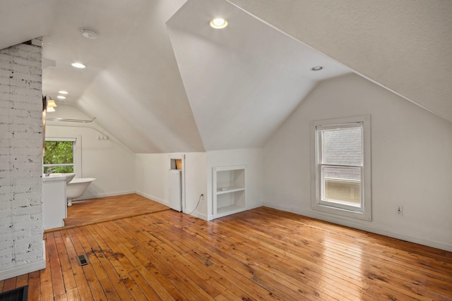 3225 Hennepin Ave, Minneapolis, MN 55408 - additional living space featuring hardwood / wood-style floors, vaulted ceiling, built in shelves, baseboards, and recessed lighting