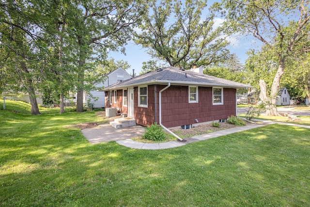 3101 Texas Ave S, Saint Louis Park, MN 55426 - rear view of house featuring a shingled roof, a chimney, and a yard