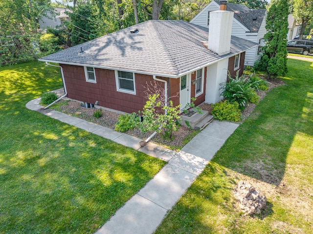 3101 Texas Ave S, Saint Louis Park, MN 55426 - view of front facade featuring a shingled roof, a chimney, and a front yard