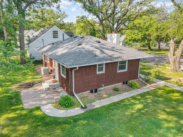 3101 Texas Ave S, Saint Louis Park, MN 55426 - view of side of home featuring a shingled roof, a chimney, and a yard
