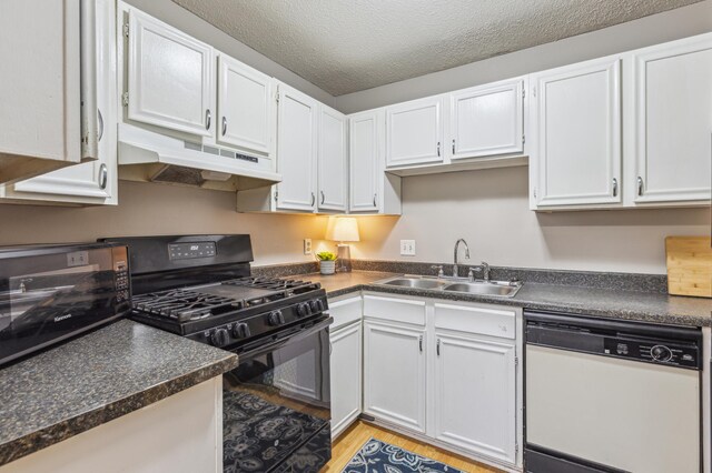 902 Ridge Dr SE, Saint Michael, MN 55376 - kitchen with black appliances, under cabinet range hood, white cabinets, and a textured ceiling