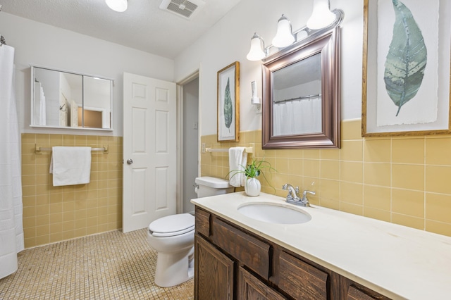 902 Ridge Dr SE, Saint Michael, MN 55376 - full bathroom with tile walls, vanity, tile patterned floors, and wainscoting