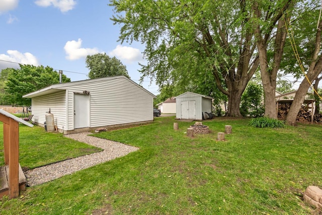 1039 9th Ave SW, Faribault, MN 55021 - view of grassy yard with an outdoor fire pit
