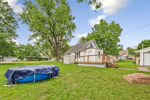 1039 9th Ave SW, Faribault, MN 55021 - view of grassy yard featuring a wooden deck and a covered pool