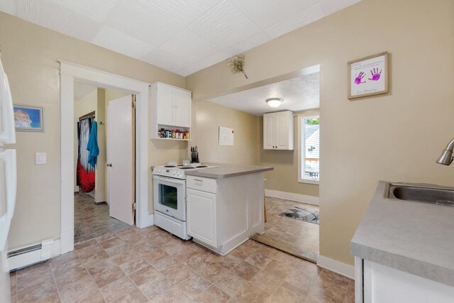 1039 9th Ave SW, Faribault, MN 55021 - kitchen featuring white electric stove, a sink, baseboard heating, and white cabinetry