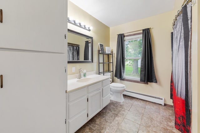 1039 9th Ave SW, Faribault, MN 55021 - full bath with baseboard heating, vanity, toilet, and tile patterned floors