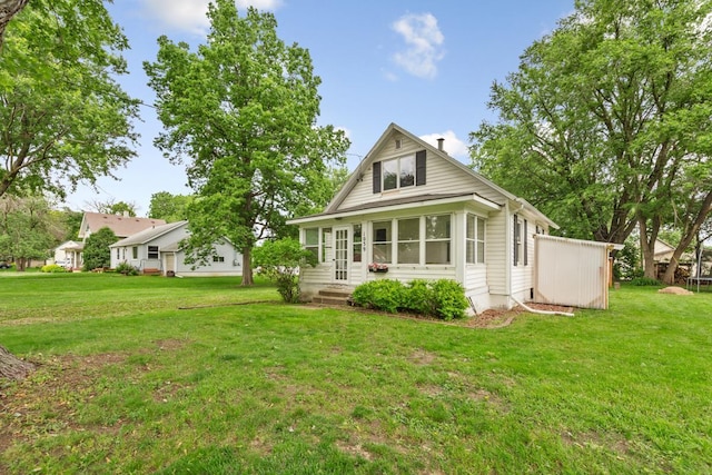 1039 9th Ave SW, Faribault, MN 55021 - back of house featuring a lawn and entry steps