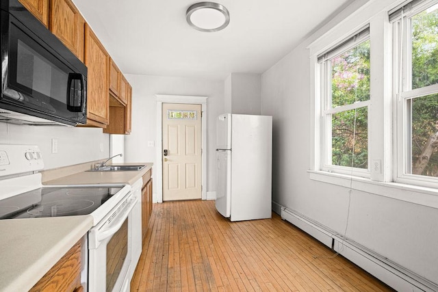 1901 5th St, Duluth, MN 55812 - kitchen with white appliances, baseboard heating, brown cabinetry, a sink, and light countertops