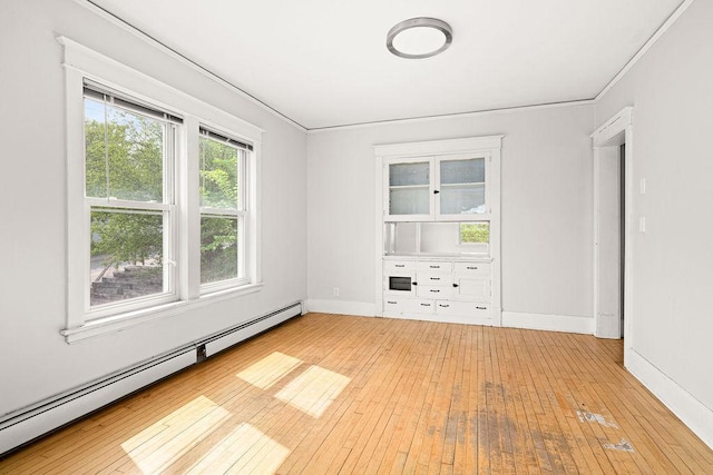 1901 5th St, Duluth, MN 55812 - unfurnished room featuring a baseboard heating unit, hardwood / wood-style floors, baseboards, and ornamental molding