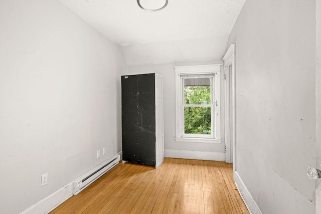 1901 5th St, Duluth, MN 55812 - unfurnished bedroom with baseboard heating, light wood-type flooring, and baseboards