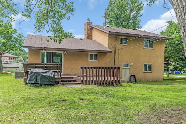495 Saint Anthony Ave, Saint Paul, MN 55103 - back of house featuring stucco siding, a chimney, a wooden deck, and a lawn