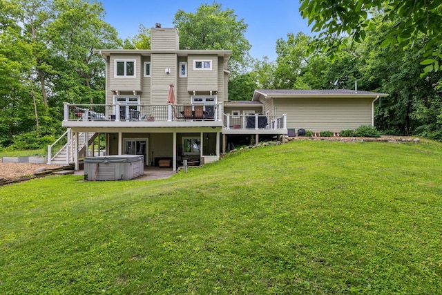10390 Fenner Ave SE, Franklin Twp, MN 55328 - back of house featuring a hot tub, a wooden deck, a lawn, and a chimney