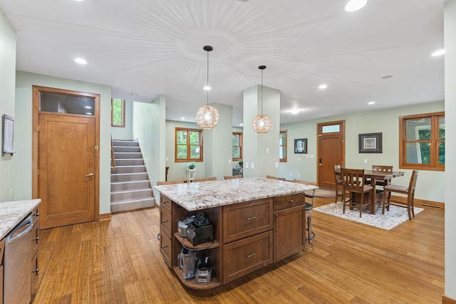 10390 Fenner Ave SE, Franklin Twp, MN 55328 - kitchen with light wood-style floors, dishwasher, pendant lighting, a kitchen island, and baseboards
