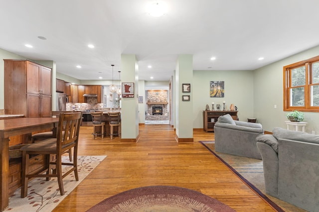 10390 Fenner Ave SE, Franklin Twp, MN 55328 - living area featuring light wood-type flooring, recessed lighting, a fireplace, and baseboards