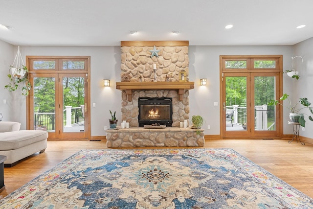 10390 Fenner Ave SE, Franklin Twp, MN 55328 - living area with wood finished floors, baseboards, recessed lighting, and a stone fireplace
