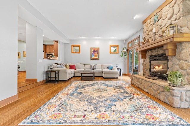 10390 Fenner Ave SE, Franklin Twp, MN 55328 - living area with wood finished floors, a fireplace, and baseboards