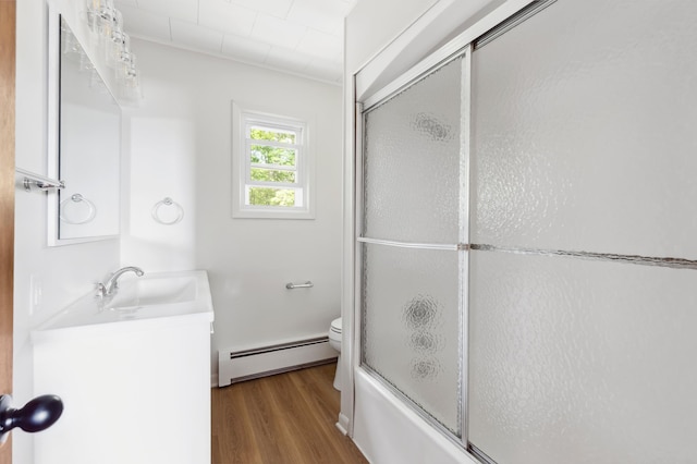 8996 Little Pelican Dr, Pelican Twp, MN 56472 - full bath featuring baseboard heating, wood finished floors, vanity, toilet, and combined bath / shower with glass door