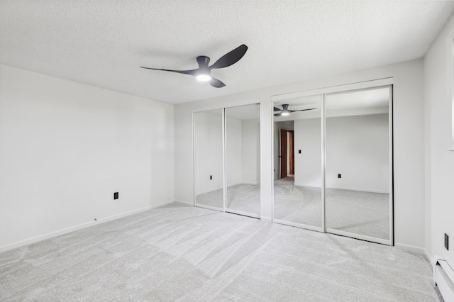 8996 Little Pelican Dr, Pelican Twp, MN 56472 - unfurnished bedroom featuring multiple closets, a textured ceiling, carpet flooring, ceiling fan, and baseboards