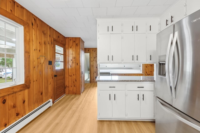 8996 Little Pelican Dr, Pelican Twp, MN 56472 - kitchen featuring stainless steel fridge, a baseboard radiator, light wood-type flooring, wooden walls, and light countertops