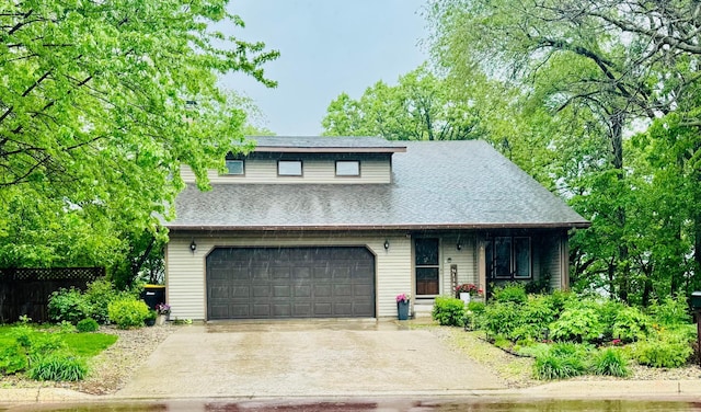606 Swain St, Redwood Falls, MN 56283 - view of front of house featuring concrete driveway, covered porch, roof with shingles, and an attached garage