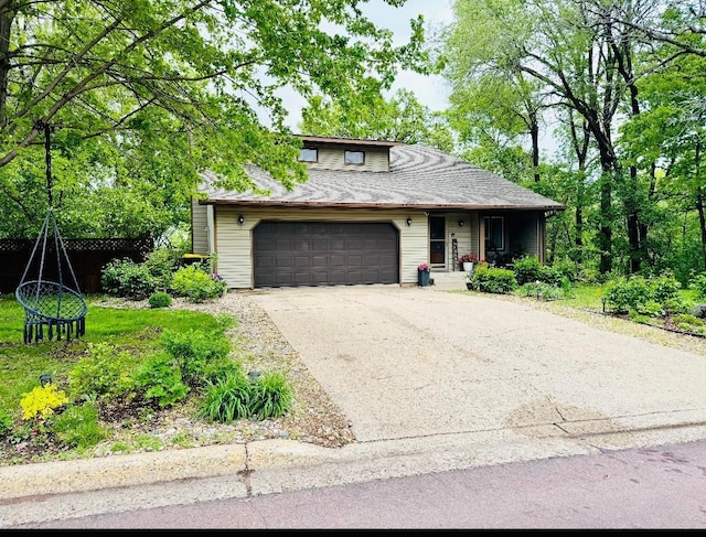 606 Swain St, Redwood Falls, MN 56283 - view of front facade featuring concrete driveway, an attached garage, and covered porch