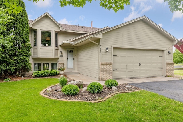 9175 Wedgwood Ln N, Maple Grove, MN 55369 - tri-level home with brick siding, asphalt driveway, an attached garage, and a front yard