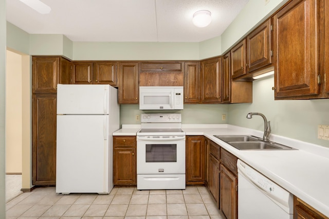 7200 York Ave S Unit 608, Edina, MN 55435 - kitchen featuring white appliances, a sink, light countertops, light tile patterned floors, and brown cabinets