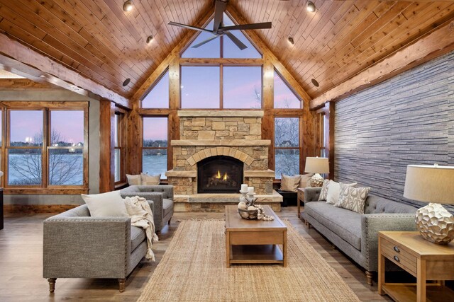 9328 Rhoy Ave, Chaska, MN 55318 - living room featuring high vaulted ceiling, wooden ceiling, a stone fireplace, wood finished floors, and a water view