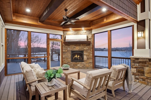 9328 Rhoy Ave, Chaska, MN 55318 - sunroom / solarium with a water view, a ceiling fan, an outdoor living space with a fireplace, beam ceiling, and plenty of natural light