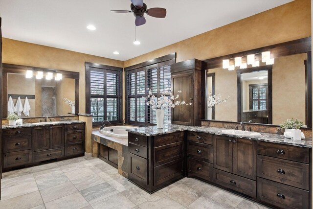 9328 Rhoy Ave, Chaska, MN 55318 - bathroom with a ceiling fan, a bath, and two vanities