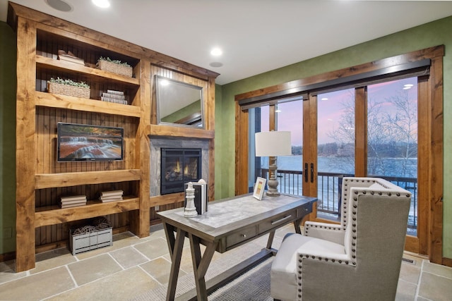 9328 Rhoy Ave, Chaska, MN 55318 - living room featuring a glass covered fireplace, stone tile flooring, recessed lighting, and a water view